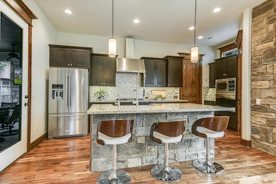 Kitchen featuring stainless steel appliances, lig