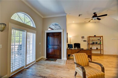 Living area, front door, sliders to large patio overlooking lake
