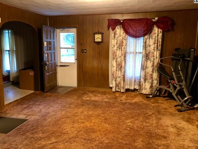 Living room looking back to front door with stairc