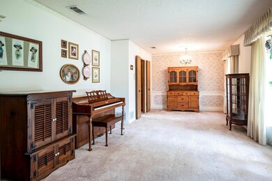 Misc room featuring crown molding, carpet, an invi