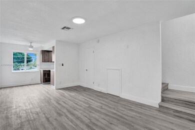 Living room, extra storage under stairs and 1/2 bath.