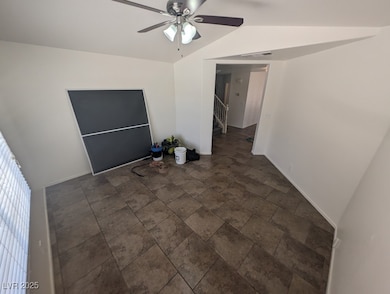 Spare room featuring lofted ceiling, stone finish