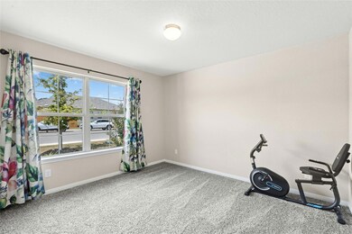 Exercise room featuring carpet flooring and a textured ceiling