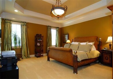 The master suite has gorgeous trim and a trayed ceiling. Custom draperies to remail!