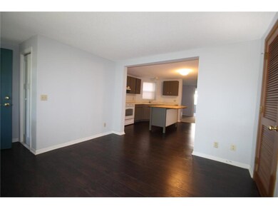 Living area with view of the kitchen.