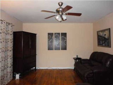 Other side of living room with ceiling fan, hardwo
