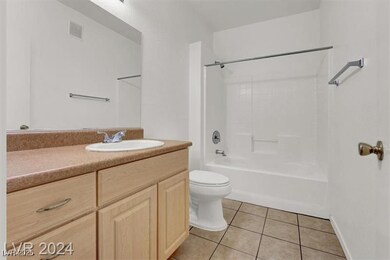 Full bathroom with light tile patterned floors, vanity, and tub / shower combination