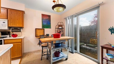 Dining area with light colored carpet and baseboards