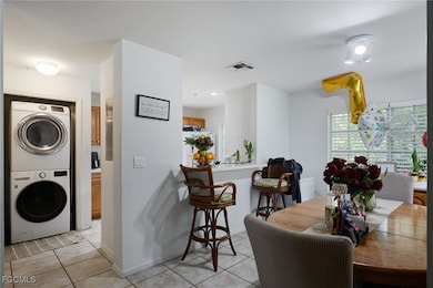 Dining room with stacked washer / drying machine a
