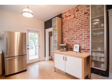 The owners exposed original brick for a modern touch in the kitchen.  Chalkboard paint for a fun accent.