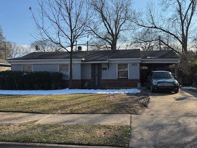 Ranch-style house with a front lawn and a carport