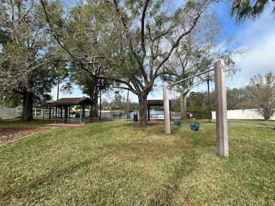 Lakefront park with a playground, pier, swimming pool, and tennis, basketball and racquetball courts!