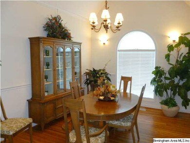 Vaulted ceiling and real hardwood flooring in this