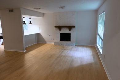 Spacious living area with a cozy painted brick fir
