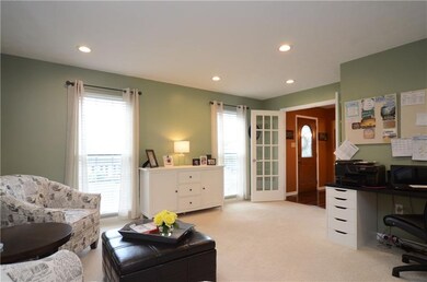 The living room is used as an office and sitting r