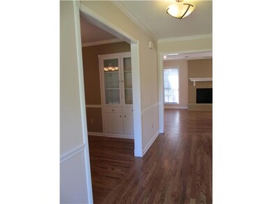 The new hardwood floors lead from the entry to Gre