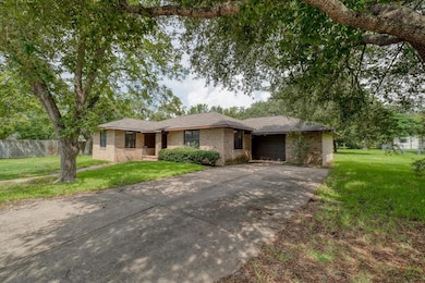 Ranch-style home featuring driveway, brick siding
