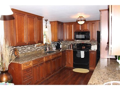 Cherry cabinetry,  ceramic and glass backsplash, n