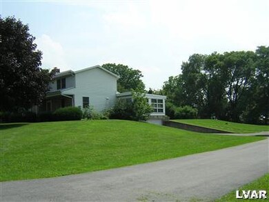 Side of house showing access to garage. To side of