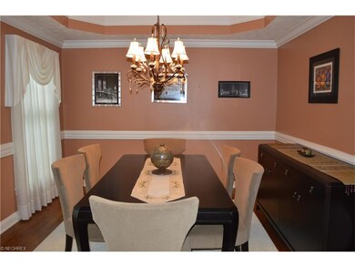 Elegant formal dining room with tray ceiling.