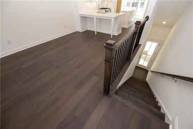 As you ascend the hardwood stairs, you find yourself on the main floor - kitchen, dining and family room.