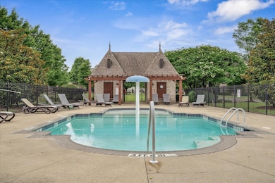 Community pool featuring a pergola and a patio area