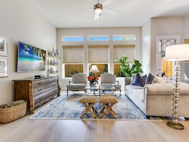 Living room featuring ceiling fan and wood finish