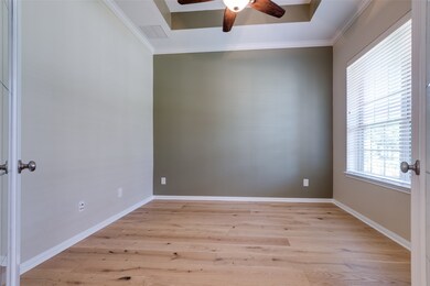 Just inside the front door you'll find a large office space with tray ceiling and tasteful paint scheme - all wired and ready for your Work at Home environment. Close the French doors to take calls while you enjoy the view of your nicely manicured front lawn.