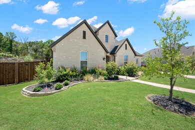 The manicured lawn and meticulously landscaped gar