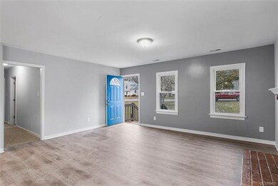 Living room view of hallway and front entrance