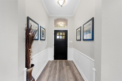 Doorway to outside featuring wainscoting, baseboar