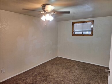 Carpeted empty room featuring ceiling fan and a textured ceiling