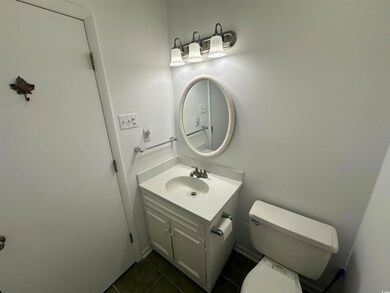 Bathroom featuring vanity, toilet, and tile patter