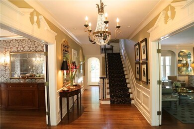 Crystal chandelier, hardwood floors and an elegant