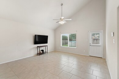 Spacious living room with door leading to backyard.