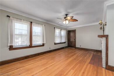 2nd floor unit Living room featuring light hardwood / wood-style flooring, crown molding, ceiling fan, and a healthy amount of sunlight