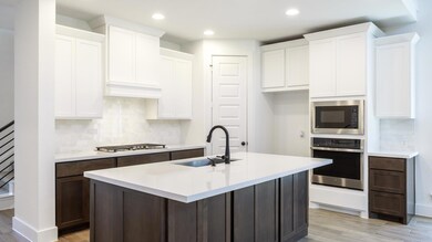 Kitchen with stainless steel appliances, light wo