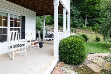 This lower-level porch also wraps around the home,