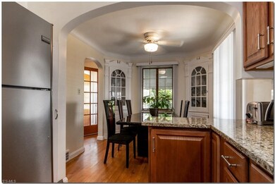 Dining Room with Corner Curio Cabinets and Hardwoo