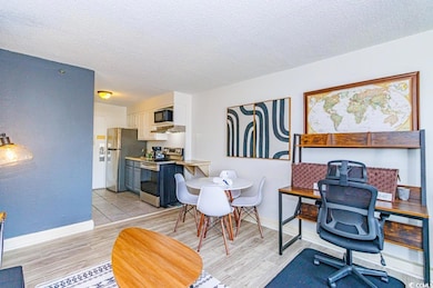 Home office with light hardwood / wood-style floor