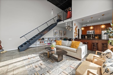Living room featuring stairway, a chandelier, a towering ceiling, and recessed lighting