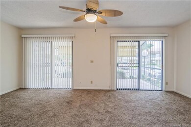Living room with 2 sliding doors to porch