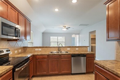 Kitchen featuring appliances with stainless steel
