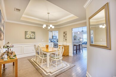 Dining area featuring ceiling fan with notable cha