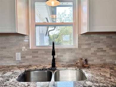 Kitchen featuring light stone countertops, plenty 