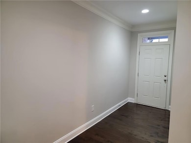 Doorway featuring baseboards, ornamental molding, 