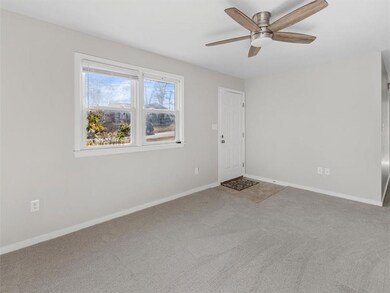 Living Room w/ updated Light/Fan Fixture, NEW Carpet, Double Windows, Front Entry