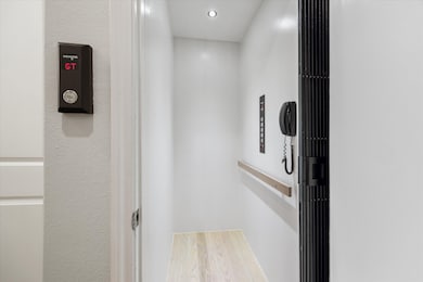  Elevator to all floors with sleek white walls and