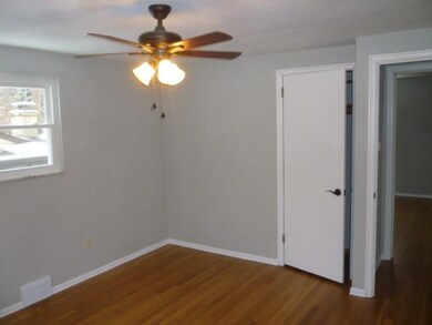 bedroom w/ refinished hardwood