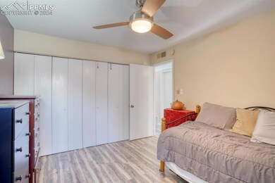 Bedroom 1- featuring LVP floors, ceiling fan, and 